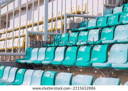 Picture of the spectator seats in an empty stadium almost no people because the match schedule on that day was empty, the green bench was photographed from below and there were numbers on each bench