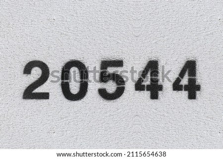 Black Number 20544 on the white wall. Spray paint.two thousand five hundred forty fourtwo thousand five hundred forty four