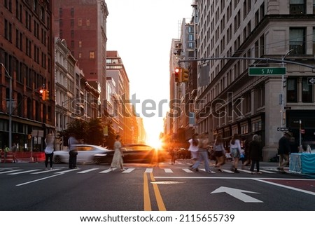 Diverse crowd of women and men walking across a busy intersection on 5th Avenue in New York City NYC Royalty-Free Stock Photo #2115655739