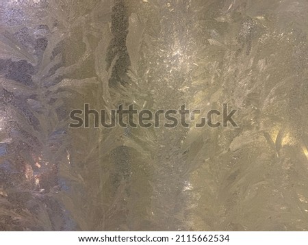 Christmas lights in a frozen window. Background
