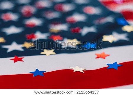 Colored shiny stars on American Flag Background. Expression of Patriotism and Love for their Country, the United States. Independence Day is July 4. Memorial Day