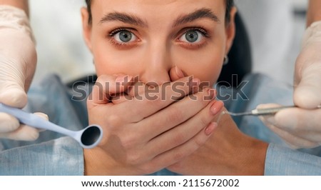 Afraid of dentist or fear of doctor. Scared and nervous patient in hospital. Upset woman with phobia having panic attack in clinic before medical operation. Royalty-Free Stock Photo #2115672002