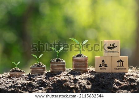 ESG concept of environmental, social, and governance.ESG icon on a woodblock with small tree on stack coins idea for esg investment sustainable organizational development. account the environment, Royalty-Free Stock Photo #2115682544