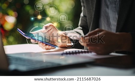 Businessman with mobile smartphone and credit card in hand paying online and shopping on virtual interface global network, online banking and digital marketing.