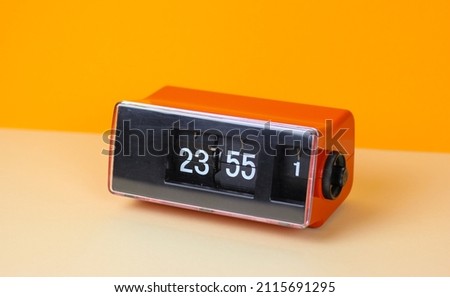 folding clock vintage retro watch clock 70s 60s object isolated number 23 55 alarm calendar used flip clock time antique space age design 1970 analog red pattern awake radio alarm counter final   Royalty-Free Stock Photo #2115691295