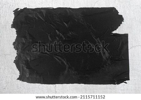 A piece of black paper pasted on the wall.