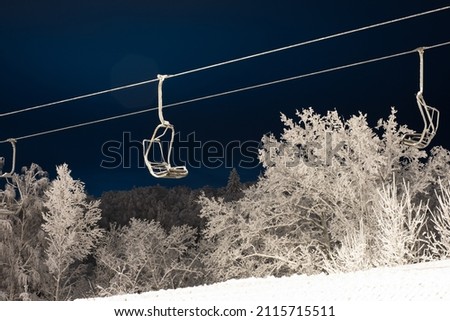 Snow-covered trees in hoarfrost at a ski resort, snow cannon, ski lift, funicular,