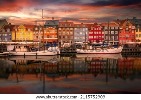 Nyhavn waterfront, canal and entertainment district at sunset. Copenhagen, Denmark Royalty-Free Stock Photo #2115752909