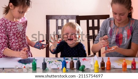 Art lessons for all aged children. Happy children with painted hands drawing pictures.