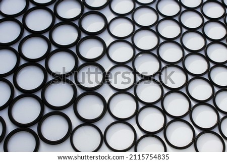 black, plastic circles of the same diameter on a white background, abstraction, background 
