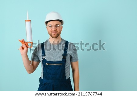 Portrait of a friendly worker. Isolated on blue