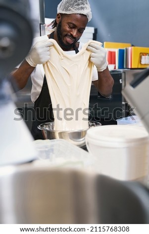 Male in protective clothes working at the kitchen
