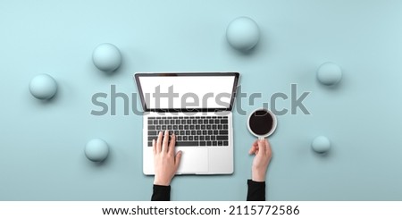 Person using a laptop computer with abstract spheres from above
