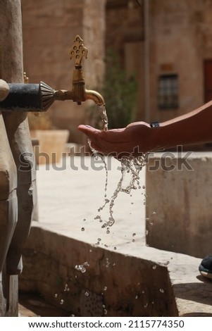 Water Is Poured Into The Palm Of Your Hand. (Ulu Mosque, Mardin, Turkey)