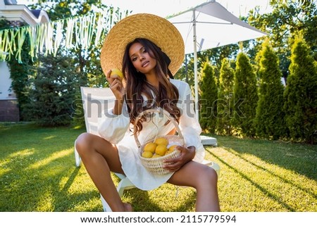 Summer portrait of an attractive dark-skinned girl in a hat. Beautiful African American Woman in Straw Hat.                     Royalty-Free Stock Photo #2115779594