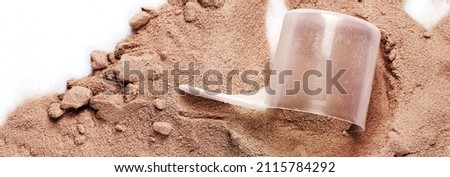 Closeup of scoop with chocolate whey protein or mass gainer powder  Royalty-Free Stock Photo #2115784292