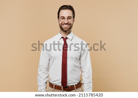 Young caucasian smiling successful employee business man corporate lawyer 20s wear classic formal white shirt red tie glasses work in office isolated on plain beige color background studio portrait Royalty-Free Stock Photo #2115785420
