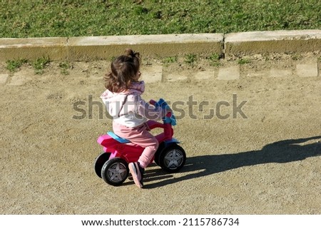 very young girl on a bike