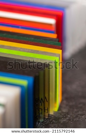 Multi-colored samples of organic glass. Colorful acrylic sheets plastic swatches, craft and decoration equipment