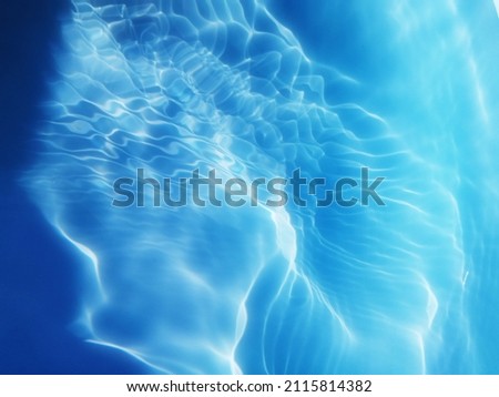 Reflection​ of​ surface​ blue​ water​ for​ background. Blue​ water​ splash​ed​ for​ background. Water​ splashed​ in deep​ sea​ for​ graphic​ design. Abstract​ of​ surface​ blue​ water​ for​ background
