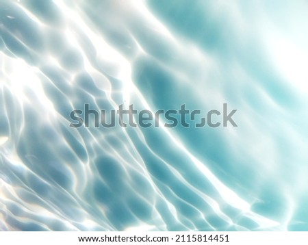 Reflection​ of​ surface​ blue​ water​ for​ background. Blue​ water​ splash​ed​ for​ background. Water​ splashed​ in deep​ sea​ for​ graphic​ design. Abstract​ of​ surface​ blue​ water​ for​ background