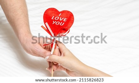 Red heart i love you  in hand of man and Woman.  Valentine's Day greeting card. Festive background. Holiday frame.