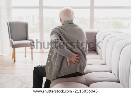 Senior old elderly man grandfather touching his back, suffering from backpain, sciatica, sedentary lifestyle concept. Spine health problems. Healthcare, insurance Royalty-Free Stock Photo #2115836045