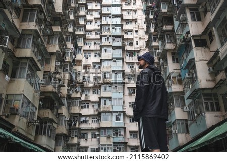 Traveler exploring the urban landscape of Hong Kong, China, one of the most densely populated cities in the world. Royalty-Free Stock Photo #2115869402