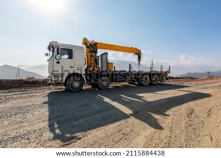View of the mobile crane with truck. It is a cable-controlled crane with a telescoping boom mounted on truck-type carriers and as self-propelled. Royalty-Free Stock Photo #2115884438