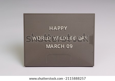 Happy holiday World Wildlife Day lettering on gray chalkboard, white background