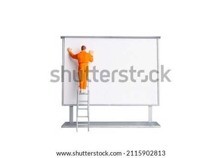 Miniature people Painter at The front of a whiteboard isolated on white background  with clipping path