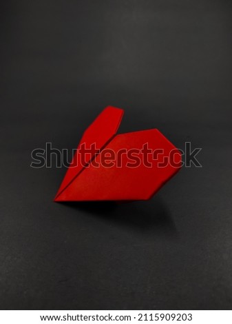Abstract Defocused Red heart shaped origami isolated on black background