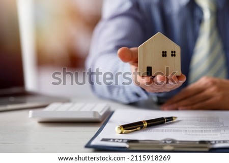 buy or sell real estate mortgage, Sale representative offer house purchase contract to buy a house or apartment and mortgage Money and Financial Concepts Royalty-Free Stock Photo #2115918269