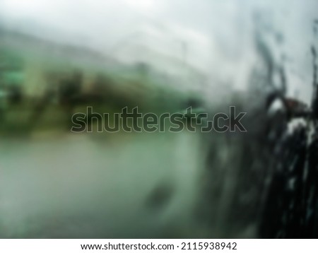 Abstract blurred background through the misted glass window