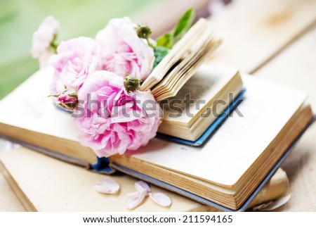Beautiful Roses with books in vintage style 
