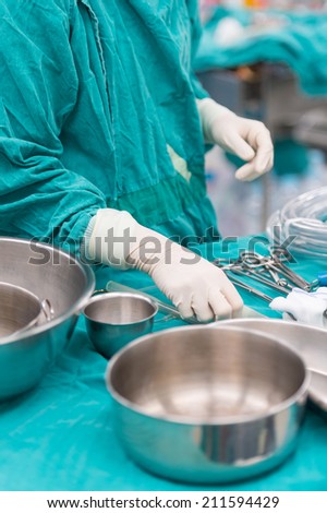 scrub nurse preparing tools for operation