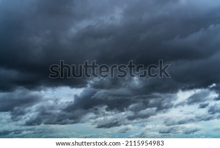 Overcast sky. Dramatic gray sky and dark clouds before rain in rainy season. Cloudy and moody sky. Storm sky. Gloomy and moody background. Overcast clouds. Sad, lonely, and death abstract background. Royalty-Free Stock Photo #2115954983