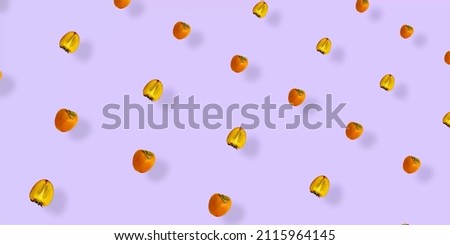 Colorful fruit pattern of fresh persimmons on purple background. Top view. Flat lay. Pop art design