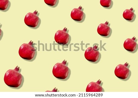 Colorful fruit pattern of fresh pomegranates on yellow background. Top view. Flat lay. Pop art design