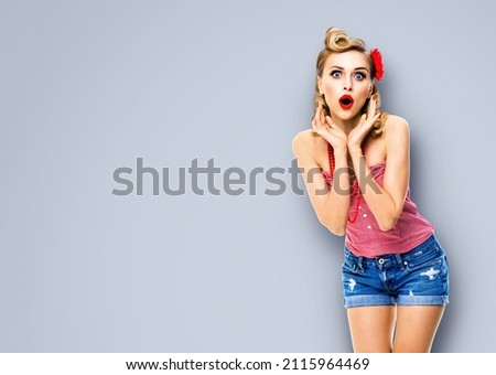 Wow! Excited surprised, astonished or very happy woman. Pin up girl with opened mouth and raised hands. Retro and vintage concept studio image. Isolated over grey background. awe awesome.