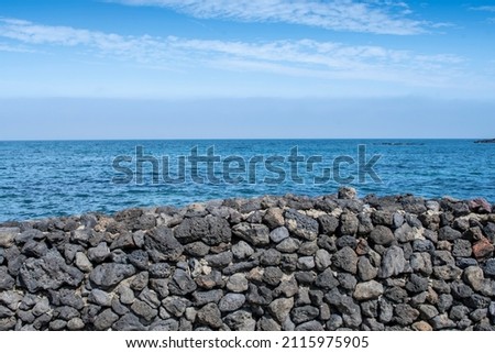The sea is beautifully harmonized with the blue sky behind the stone wall. A high-resolution photo source that's good for editing with handwriting.