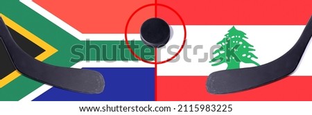 Top view hockey puck with South Africa vs. Lebanon command with the sticks on the flag. Concept hockey competitions
