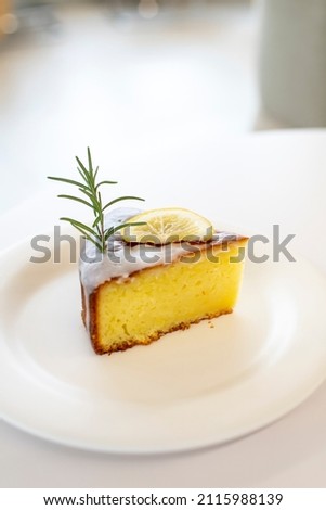 A delicious lemon cake with rosemary as decoration. Dessert picture.