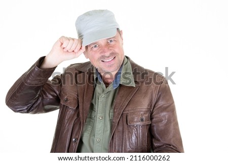 handsome middle aged man with his hand on his military cap on white background