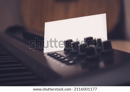 Mockup of a business card that sticks out in a synthesizer or midi keyboard