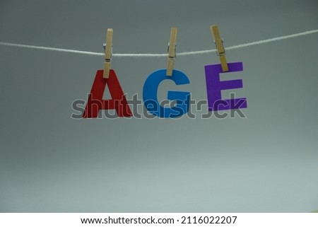 Word 'age' on white background. Age means the period of time someone has been alive or something has existed. Concept for learning, education, and preschool.
