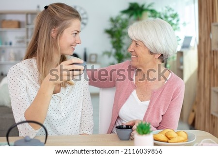 young daughter and senior mother on the cheek