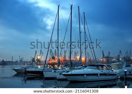 Yachts and boats after sunset in the harbor. Black Sea, Varna, Bulgaria.