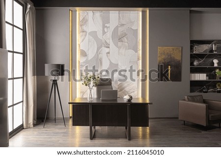 stylish luxury home office interior in an ultramodern brutal apartment in dark colors and cool led lighting Royalty-Free Stock Photo #2116045010