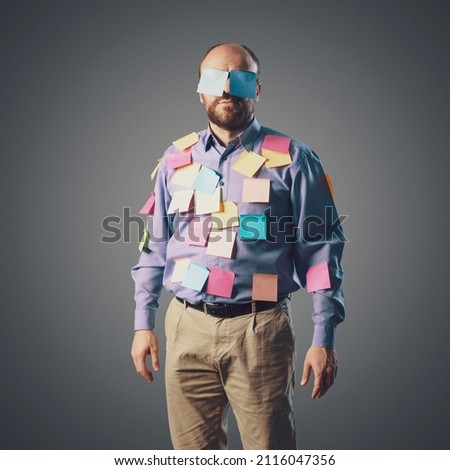 Funny businessman covered with sticky notes, he is looking at camera Royalty-Free Stock Photo #2116047356